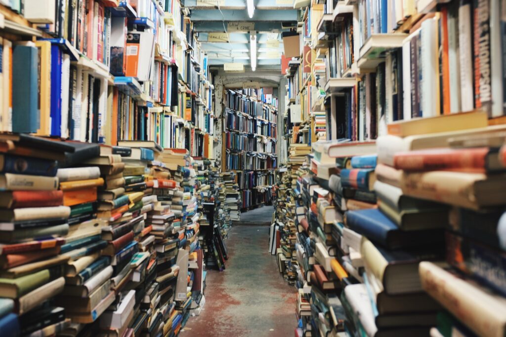 stacks of books piled from floor to ceiling
