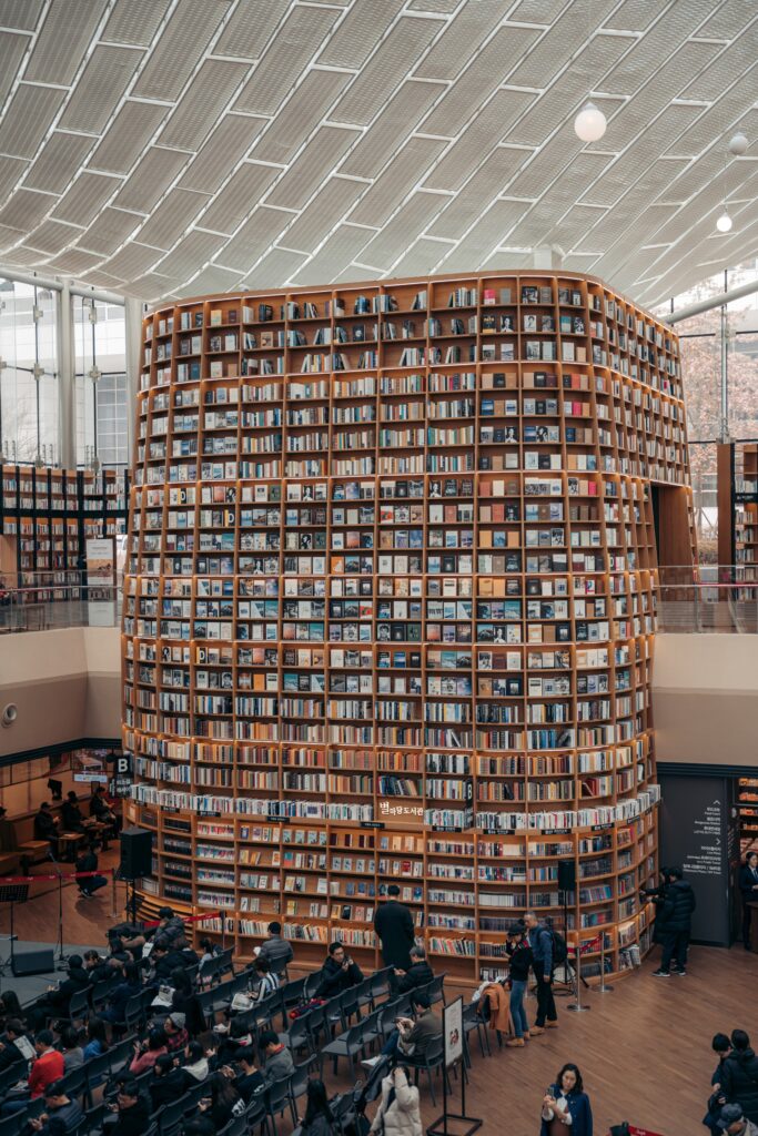 Towering structure of shelves containing books and media reaching over two stories high.